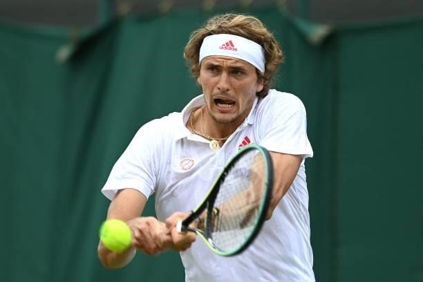 Germany's Alexander Zverev returns to US player Taylor Fritz during their men's singles third round match on the sixth day of the 2021 Wimbledon...