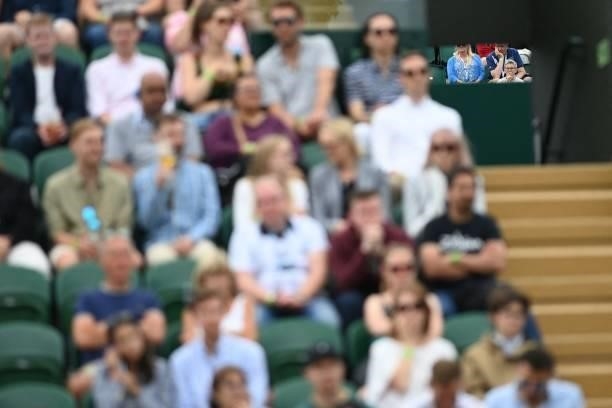 Spectators watch the action on court 12 through the gantry on the sixth day of the 2021 Wimbledon Championships at The All England Tennis Club in...