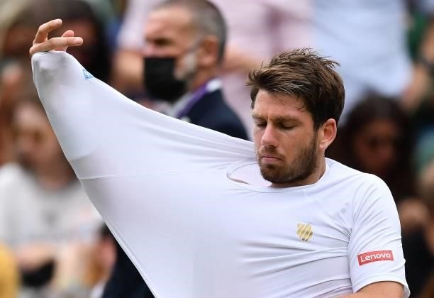Britain's Cameron Norrie changes shirts during a break in play against Switzerland's Roger Federer during at men's singles third round match on the...