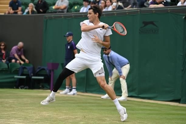 Player Taylor Fritz returns to Germany's Alexander Zverev during their men's singles third round match on the sixth day of the 2021 Wimbledon...