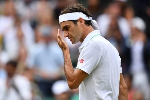 Switzerland's Roger Federer wipes his face after winning the second set against Britain's Cameron Norrie during their men's singles third round match...