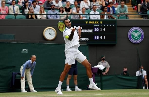 Australia's Nick Kyrgios returns against Canada's Felix Auger-Aliassime during their men's singles third round match on the sixth day of the 2021...