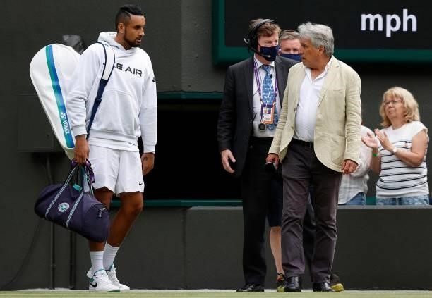Presenter John Inverdale talks Australia's Nick Kyrgios into speaking to the crowd after withrawing from his match against Canada's Felix...