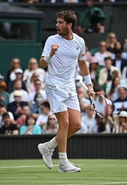 Britain's Cameron Norrie celebrates winning a game in the second set against Switzerland's Roger Federer during their men's singles third round match...