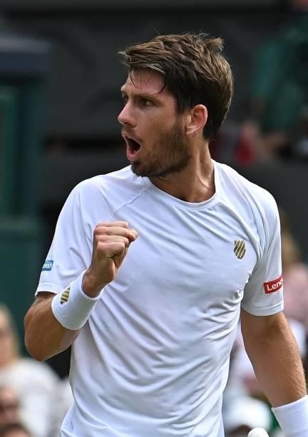 Britain's Cameron Norrie celebrates winning a game in the second set against Switzerland's Roger Federer during their men's singles third round match...