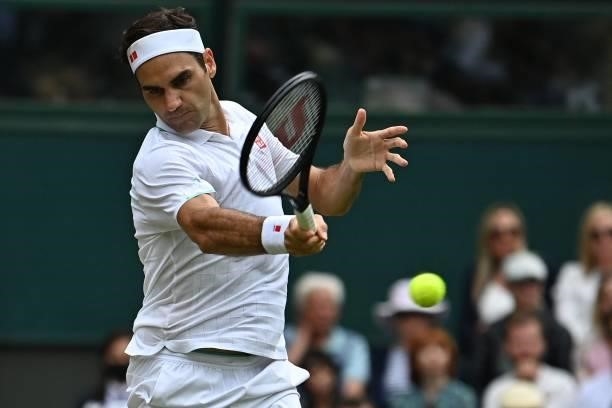 Switzerland's Roger Federer returns against Britain's Cameron Norrie during their men's singles third round match on the sixth day of the 2021...