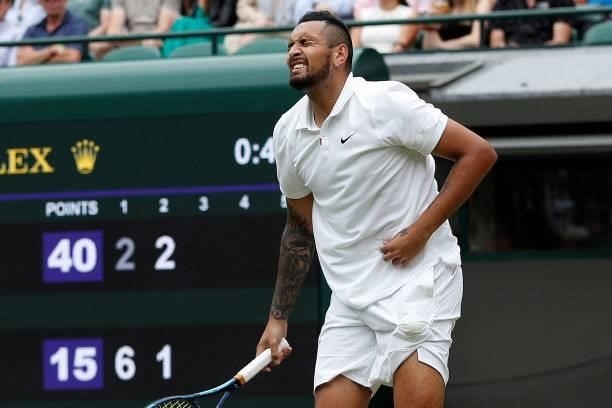 Australia's Nick Kyrgios reacts in pain after serving against Canada's Felix Auger-Aliassime during their men's singles third round match on the...