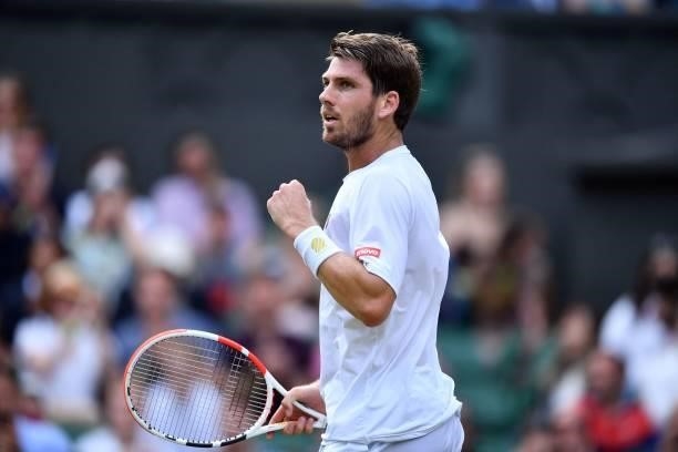 Britain's Cameron Norrie celebrates winning a game against Switzerland's Roger Federer during their men's singles third round match on the sixth day...