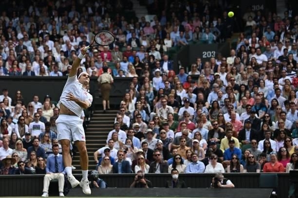 Switzerland's Roger Federer returns a lob against Britain's Cameron Norrie during their men's singles third round match on the sixth day of the 2021...