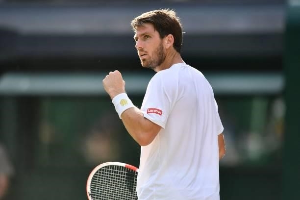 Britain's Cameron Norrie celebrates breaking serve against Switzerland's Roger Federer during their men's singles third round match on the sixth day...