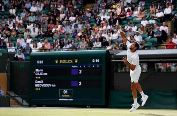 Croatia's Marin Cilic serves against Russia's Daniil Medvedev during their men's singles third round match on the sixth day of the 2021 Wimbledon...