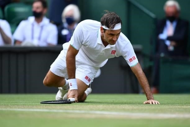 Switzerland's Roger Federer slips during play against Britain's Cameron Norrie during their men's singles third round match on the sixth day of the...