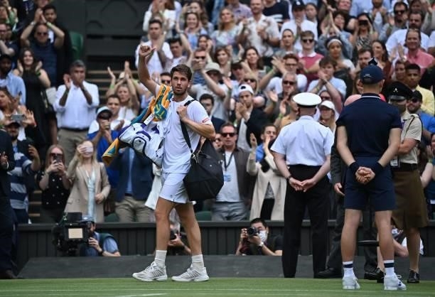 Britain's Cameron Norrie leaves the court after losing to Switzerland's Roger Federer during their men's singles third round match on the sixth day...