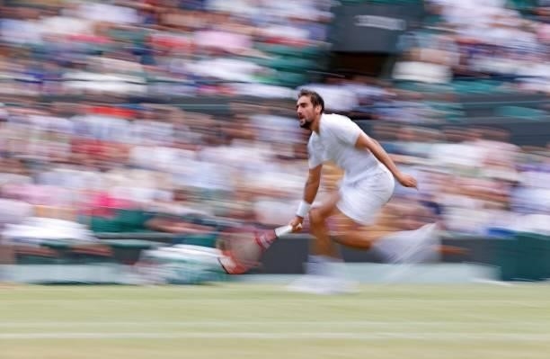 Croatia's Marin Cilic runs to play a shot to Russia's Daniil Medvedev during their men's singles third round match on the sixth day of the 2021...