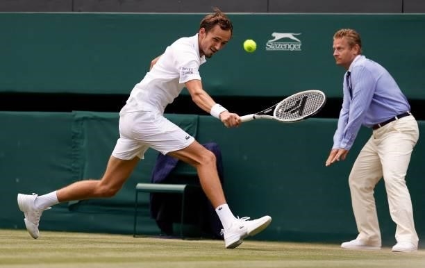 Russia's Daniil Medvedev returns against Croatia's Marin Cilic during their men's singles third round match on the sixth day of the 2021 Wimbledon...