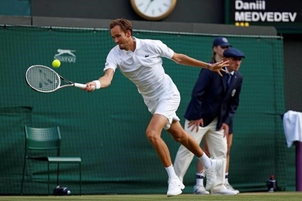 Russia's Daniil Medvedev returns against Croatia's Marin Cilic during their men's singles third round match on the sixth day of the 2021 Wimbledon...