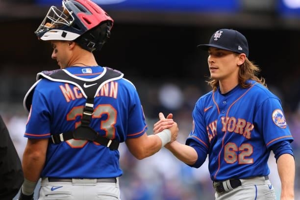 Catcher James McCann and pitcher Drew Smith of the New York Mets shake hands after defeating the New York Yankees 8-3 in a game at Yankee Stadium on...