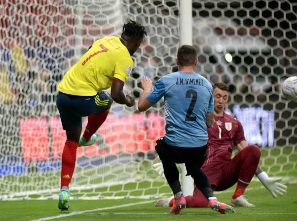 Duvan Zapata of Colombia competes for the ball with Fernando Muslera and Jose Gimenez of Uruguay ,during the Quarterfinal match between Uruguay and...