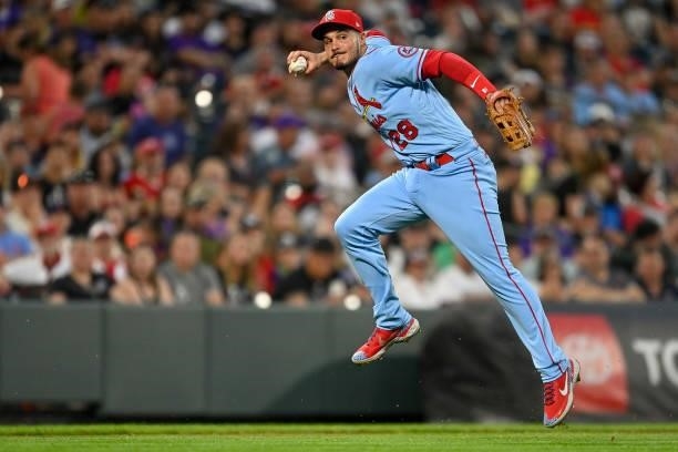 Nolan Arenado of the St. Louis Cardinals leaps before throwing to first base to attempt a force out against the Colorado Rockies at Coors Field on...