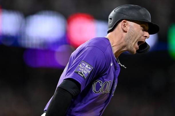 Trevor Story of the Colorado Rockies celebrates after hitting a seventh inning three-run homerun against the St. Louis Cardinals during a game at...