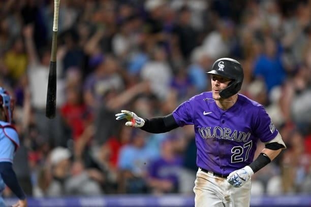 Trevor Story of the Colorado Rockies tosses his bat after hitting a seventh inning three-run homerun against the St. Louis Cardinals during a game at...