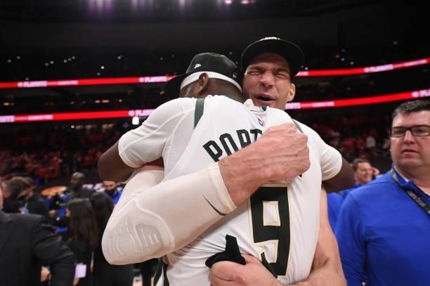 Brook Lopez of the Milwaukee Bucks hugs teammate Bobby Portis after the game against the Atlanta Hawks during Game 6 of the Eastern Conference Finals...