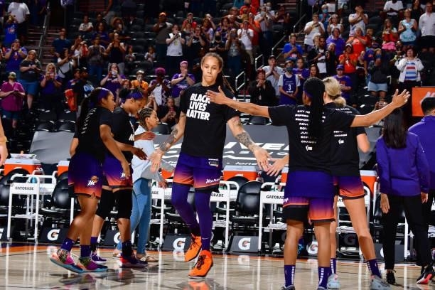 Brittney Griner of the Phoenix Mercury high fives her teammates before the game against the Minnesota Lynx on July 3, 2021 at the Phoenix Suns Arena...