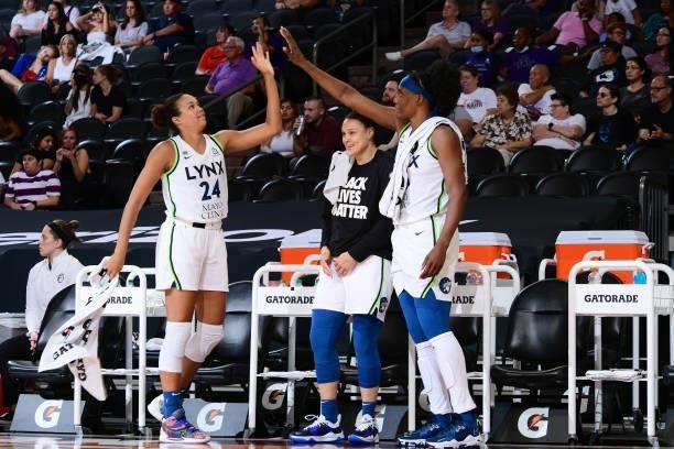 Napheesa Collier of the Minnesota Lynx high-fives teammate Sylvia Fowles during the game against the Phoenix Mercury on July 3, 2021 at Phoenix Suns...