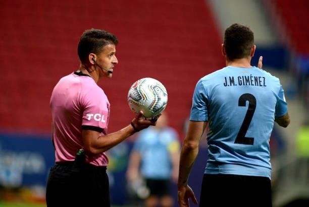Spanish referee Jesus Gil Manzano reacts with Jose Gimenez of Uruguay during the Quarterfinal match between Uruguay and Colombia as part of Conmebol...