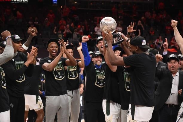 Khris Middleton of the Milwaukee Bucks holds up the Eastern Conference Finals Trophy after the game against the Atlanta Hawks during Game 6 of the...