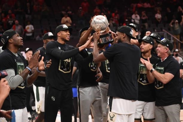 Khris Middleton of the Milwaukee Bucks holds up the Eastern Conference Finals Trophy after the game against the Atlanta Hawks during Game 6 of the...