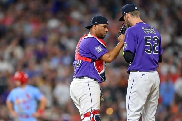 Elias Diaz of the Colorado Rockies has a word with Daniel Bard as St. Louis Cardinals runners stand at second and third base in the ninth inning of a...