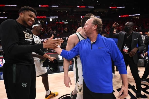 Giannis Antetokounmpo of the Milwaukee Bucks high-fives Head Coach Mike Budenholzer after the game against the Atlanta Hawks during Game 6 of the...