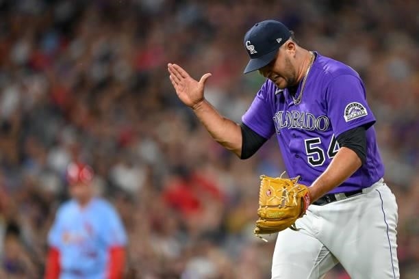 Carlos Estevez of the Colorado Rockies reacts after striking out Harrison Bader of the St. Louis Cardinals for the third out of the top of the eighth...
