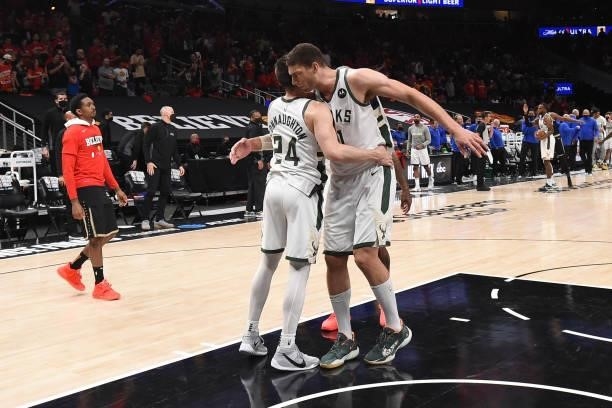 Brook Lopez of the Milwaukee Bucks hugs teammate Pat Connaughton after the game against the Atlanta Hawks during Game 6 of the Eastern Conference...