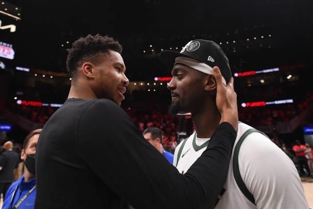 Giannis Antetokounmpo of the Milwaukee Bucks embraces teammate Bobby Portis after the game against the Atlanta Hawks during Game 6 of the Eastern...
