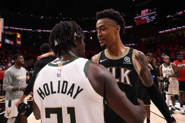 John Collins of the Atlanta Hawks hugs Jrue Holiday of the Milwaukee Bucks after the game during Game 6 of the Eastern Conference Finals of the 2021...