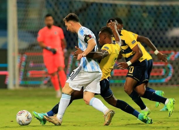 Lionel Messi of Argentina competes for the ball with Pervis Estupinan and Jhegson Mendez of Ecuador , during the Quarterfinal match between Argentina...