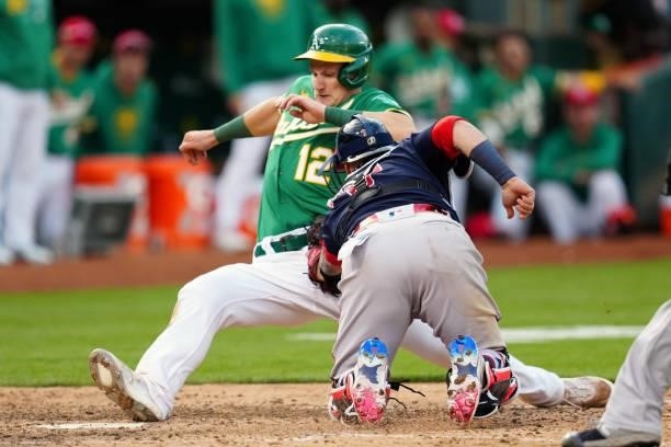 Christian Vázquez of the Boston Red Sox tags out Sean Murphy of the Oakland Athletics at home plate during the game at Oakland Coliseum on Saturday,...
