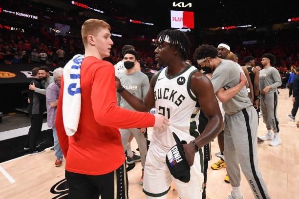 Kevin Huerter of the Atlanta Hawks congratulates Jrue Holiday of the Milwaukee Bucks after the game during Game 6 of the Eastern Conference Finals of...