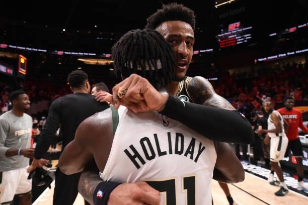 John Collins of the Atlanta Hawks hugs Jrue Holiday of the Milwaukee Bucks after the game during Game 6 of the Eastern Conference Finals of the 2021...
