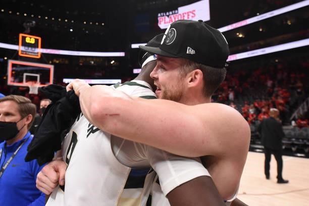 Pat Connaughton of the Milwaukee Bucks hugs teammate Bobby Portis after the game against the Atlanta Hawks during Game 6 of the Eastern Conference...