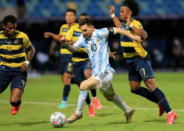 Lionel Messi of Argentina competes for the ball with Angelo Preciado and Robert Arboleda of Ecuador during the Conmebol Copa America Brazil 2021...