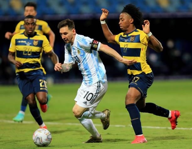 Lionel Messi of Argentina competes for the ball with Angelo Preciado of Ecuador during the Conmebol Copa America Brazil 2021 quarter-final between...