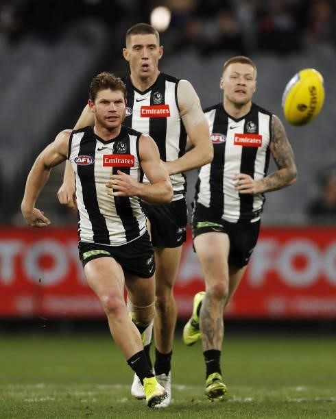 Taylor Adams of the Magpies, Darcy Cameron of the Magpies and Jordan De Goey of the Magpies in action during the 2021 AFL Round 16 match between the...