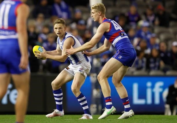 Jack Ziebell of the Kangaroos and Tim English of the Bulldogs in action during the 2021 AFL Round 16 match between the Western Bulldogs and the North...