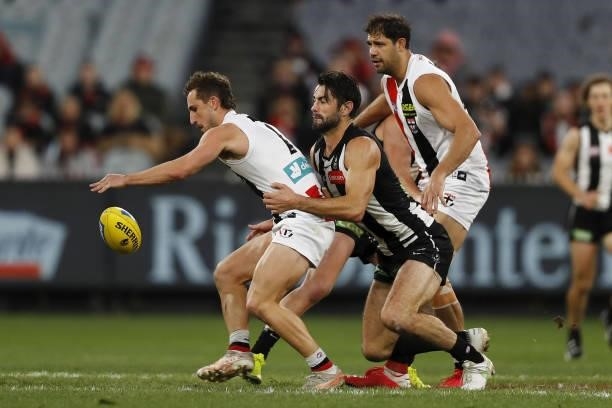 Luke Dunstan of the Saints is tackled by Brodie Grundy of the Magpies during the 2021 AFL Round 16 match between the Collingwood Magpies and the St...