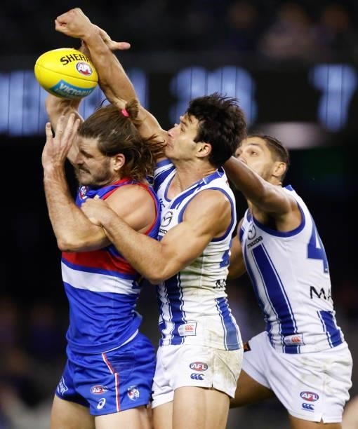 Josh Bruce of the Bulldogs and Robbie Tarrant of the Kangaroos compete for the ball during the 2021 AFL Round 16 match between the Western Bulldogs...