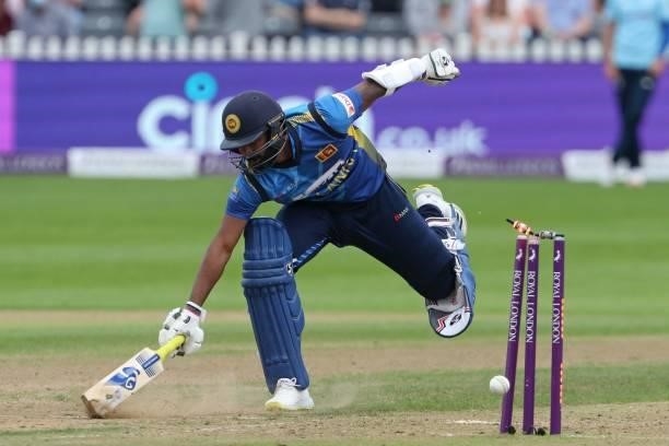 Sri Lanka's Chamika Karunaratne just makes his ground as a throw from England's Chris Woakes breaks the stumps during the third one-day international...