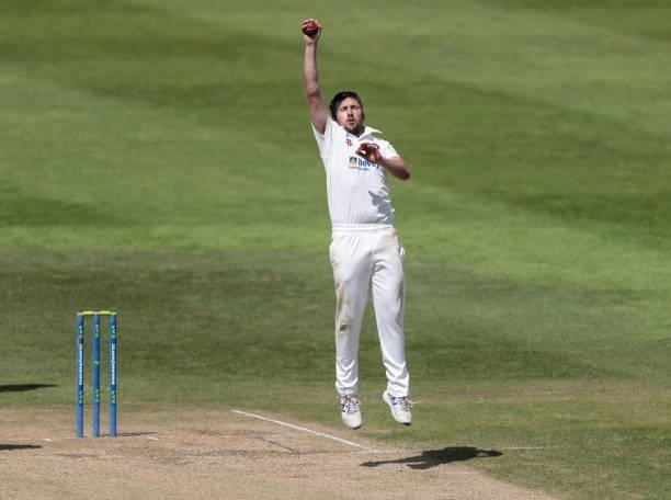 Simon Kerrigan of Northamptonshire fields off of his own bowling during day one of the LV= Insurance County Championship match between...